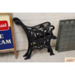 A pair of black cast iron bench ends