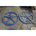 A pair of blue painted heavy iron wheels