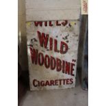 A "Wills Wild Woodbine Cigarettes" enamel advertisi