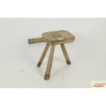 A 19th Century three legged milking stool