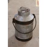 A small metal ware milk churn with swing handle
