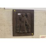 A carved wooden panel in a carved frame depicting an