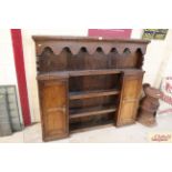 A Georgian oak dresser top with two side cupboards and various shelves’ measuring approximately 55