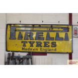 A large "Pirelli Tyres Made In England" enamel sig