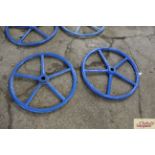 A pair of blue painted heavy iron wheels