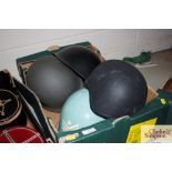 A box of various military helmets