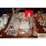 A collection of various cut glass tableware