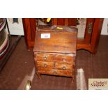 A miniature antique pine bureau