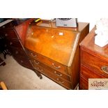 A walnut bureau on cabriole supports