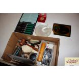 A box of miscellaneous items to include a corkscrew