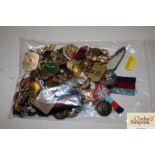 A bag of mixed badges, buttons etc.