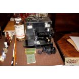 A cased Singer 221K sewing machine and accessories