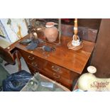 An Edwardian chest of three long drawers and a rep