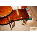 A nest of three mahogany occasional tables