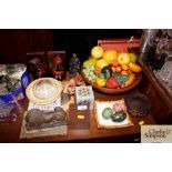 A wooden bowl and contents of various plastic frui