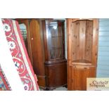 A reproduction mahogany corner cabinet