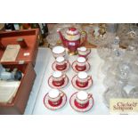 A quantity of Shelley red and gilt coffee ware