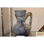 An antique coloured glass baluster jug