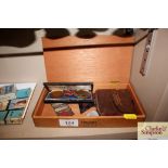 A wooden cigar box and contents of various medals,