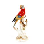 A German porcelain study of a parrot, perched on a tree stump, 31cm high