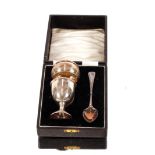 A cased silver egg cup, spoon, and napkin ring,