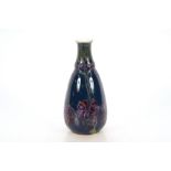 An Art Nouveau K.P.M. Berlin porcelain vase, trailing floral decoration on a blue ground, orb and