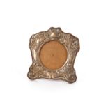An Edwardian silver mounted easel photograph frame, in the Art Nouveau taste with raised floral