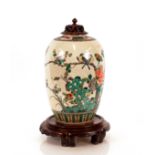 An Oriental crackle glazed baluster vase, decorated birds and foliage with a carved pierced hard