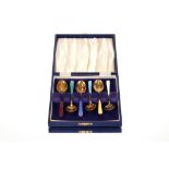 A cased set of six silver gilt and enamel coffee spoons