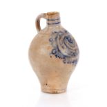 An antique Rhenish ware pottery flagon, having stylised blue floral scroll decoration on a grey