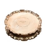 A presentation silver salver, with pie crust border raised on three scroll feet, London 1948; 18oz