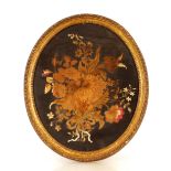 An antique oval needlework study, of flowers dated 1779, 57cm x 47cm contained in a gilt rope