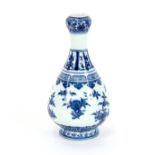 A Ming style Chinese porcelain blue and white bottle vase, painted with six fruiting and flowering