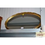 An oval gilt framed wall mirror