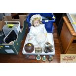 A doll, small travelling clock, various small figu