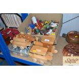 A wooden toy train and a collection of plastic Cow