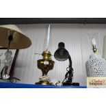 A desk lamp with a brass oil lamp converted into a