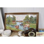 An oak framed tiled picture of cows watering, mono