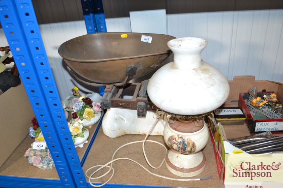 A set of scales and collection of weights and a table lamp