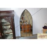 An arched outdoor mirror
