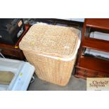 A wicker laundry bin together with a drop leaf bed
