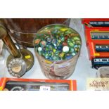 A tin of various marbles