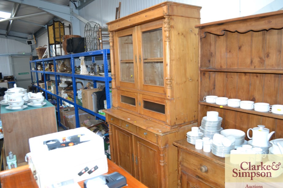 A Continental pine and glazed cabinet raised on cu