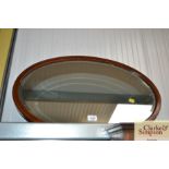 An Edwardian oval framed and bevel edged mirror