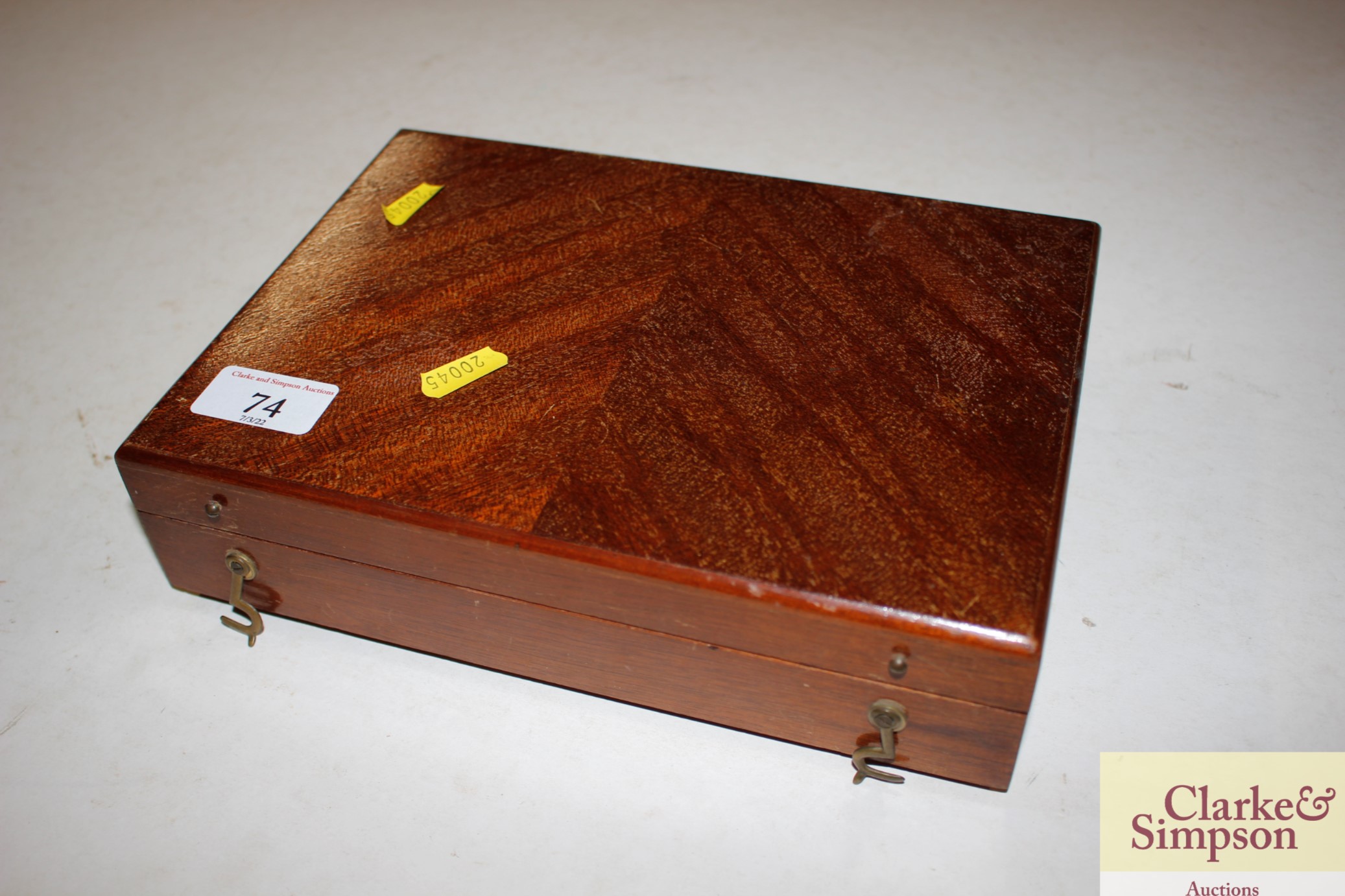 A mahogany box with contents of a pottery tray and