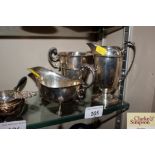 A silver sauce boat; a trophy cup; and a plated cr