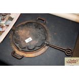 A cast waffle iron, inscribed 'F' beneath a crown,
