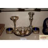A silver spill vase; a pair of slats; candlestick;