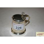 A silver drum shaped mustard pot