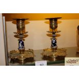 A pair of Victorian brass and pottery candlesticks